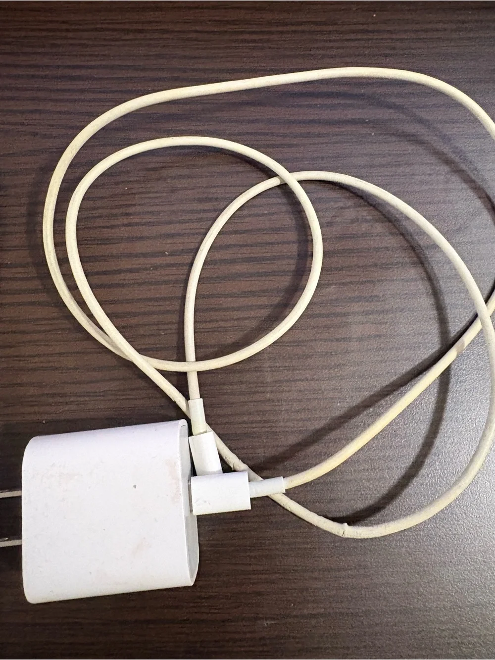 White Smartphone with White Charging Cable and Wall Adapter